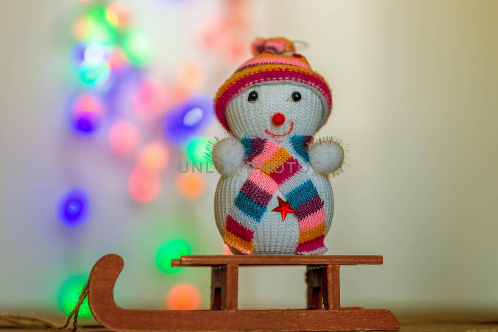 Christmas background with a snowman sitting on a sled