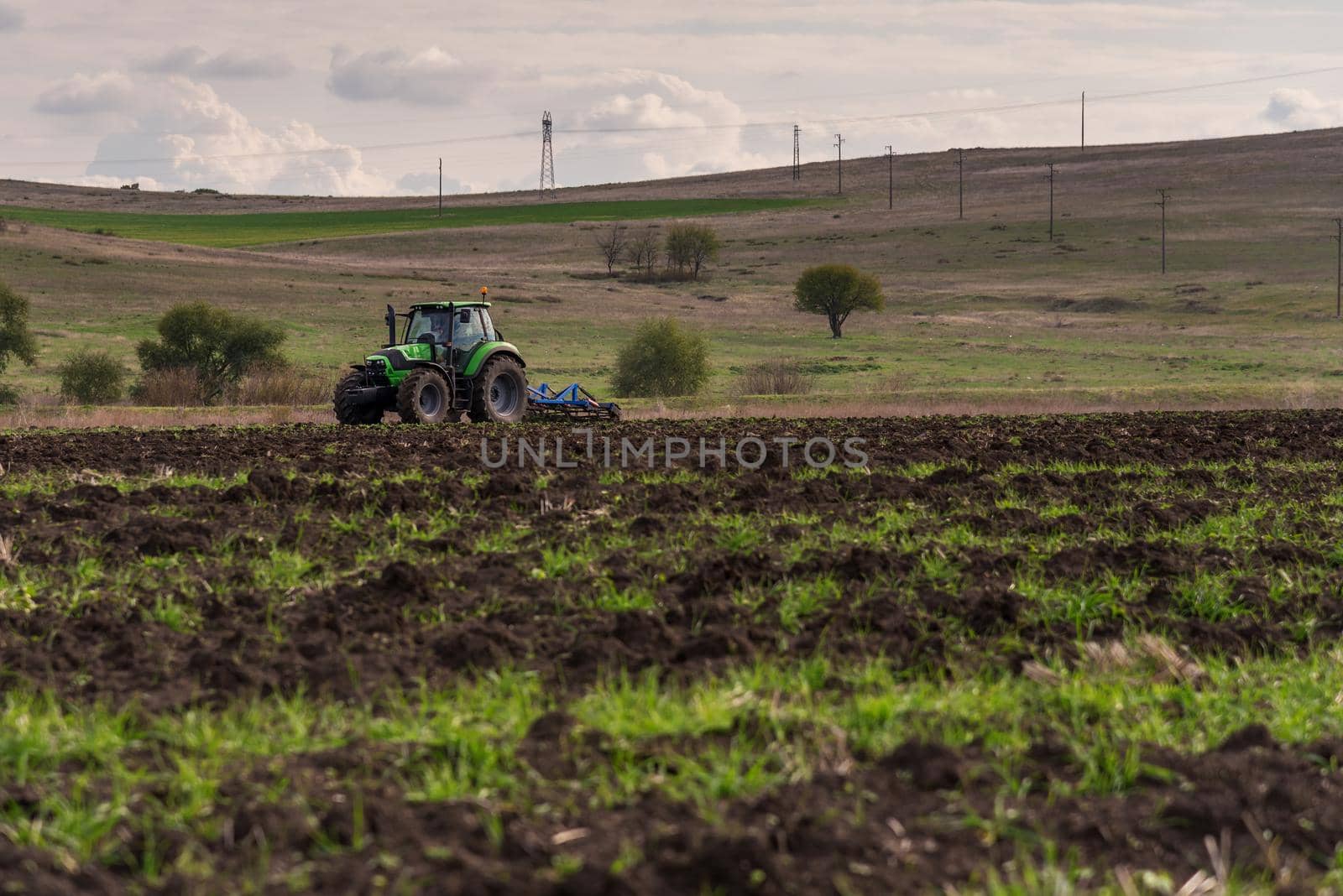 Tractor plowing fields. Preparing land for sowing in autumn.