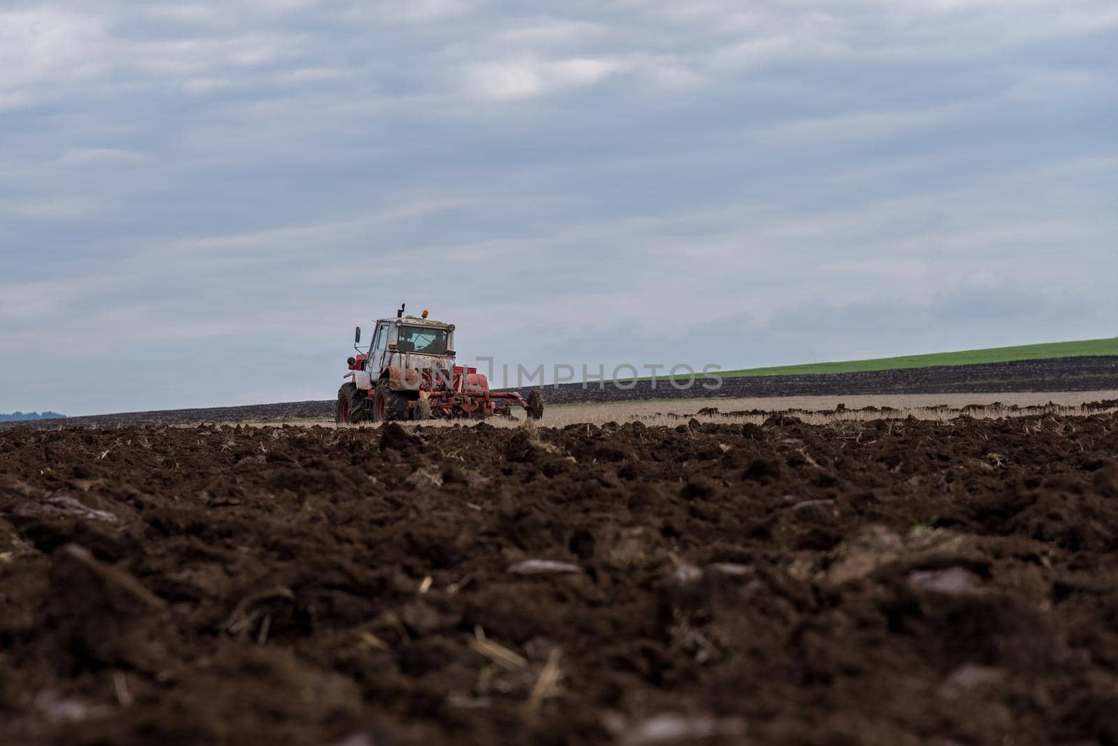 Tractor plowing fields. Preparing land for sowing in autumn.