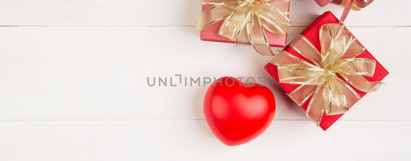 Gift box and heart shape on wooden table background, love and romance, presents in celebration and anniversary with surprise on desk, happy birthday, donate and charity, valentine day concept. by nnudoo
