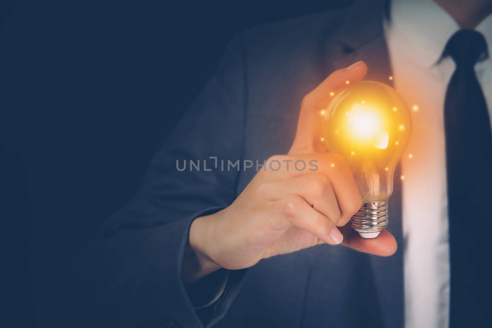Businessman holding light bulb, imagination and intelligence, innovation and inspiration, brain symbol and solution and knowledge, creative idea and success, business and marketing concept.