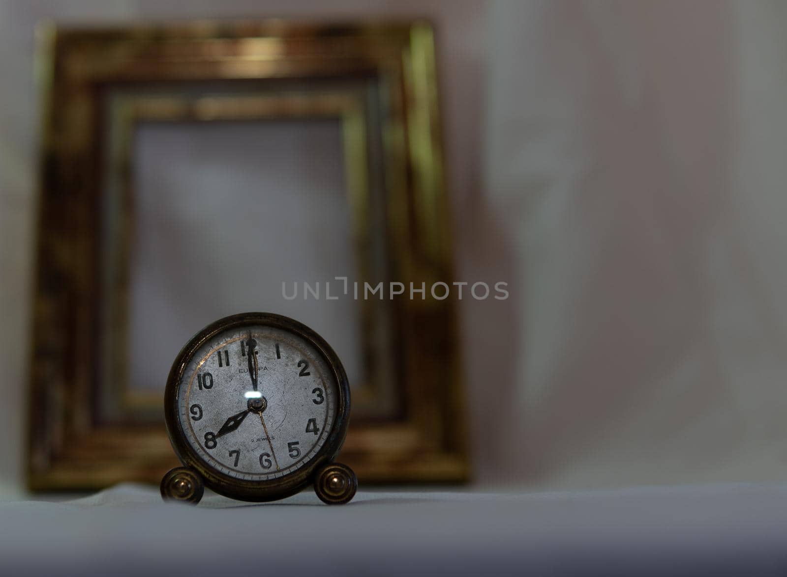 Vintage clock with white background and gold frame