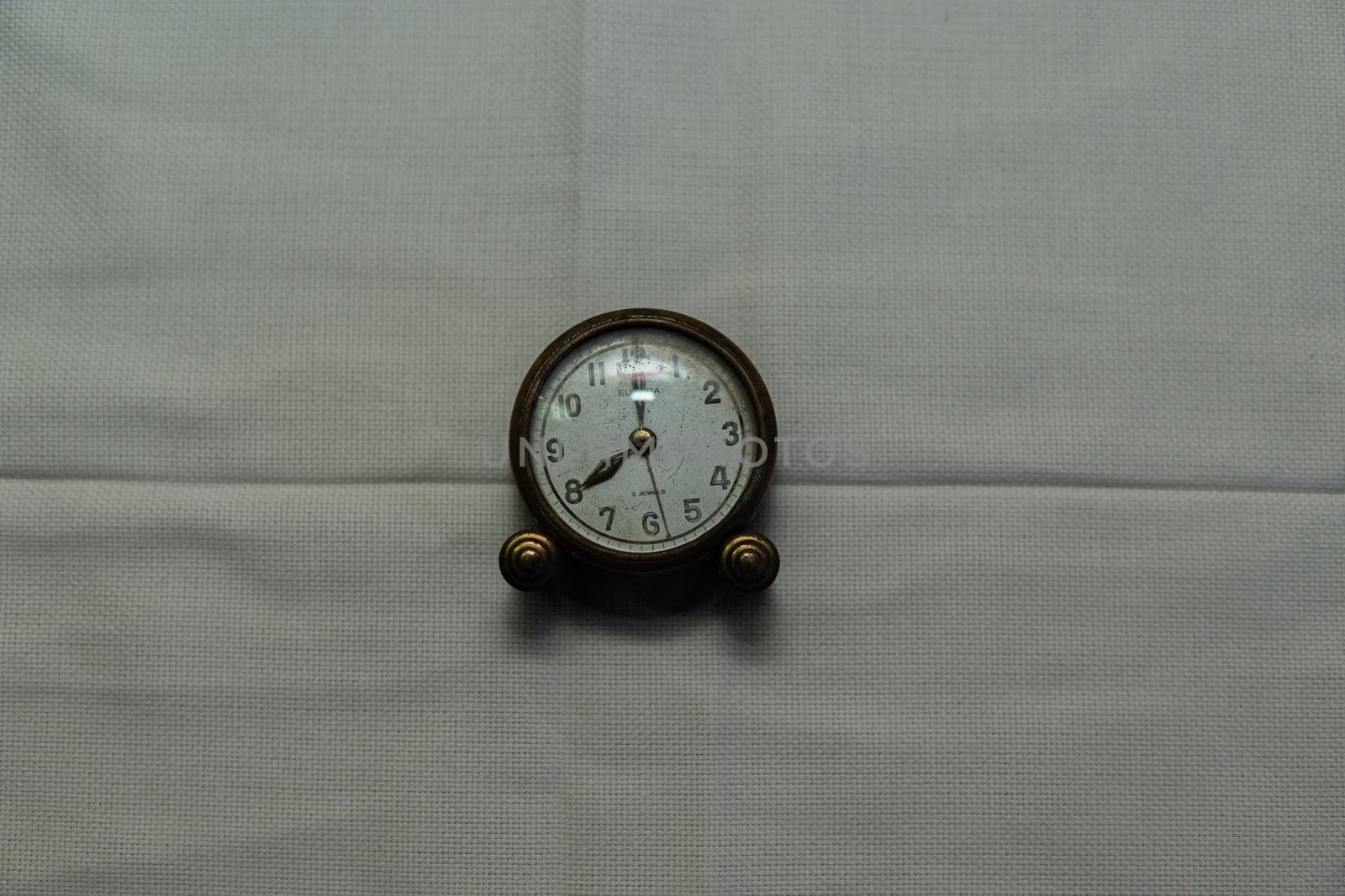 Centered vintage clock with white fabric backing by xavier_photo