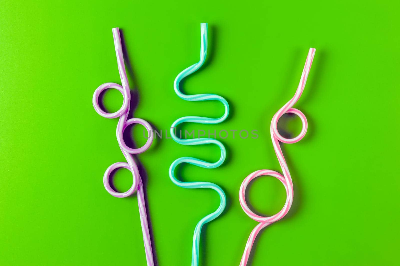 tubes for drinks on a green background macro. place for the label. High quality photo