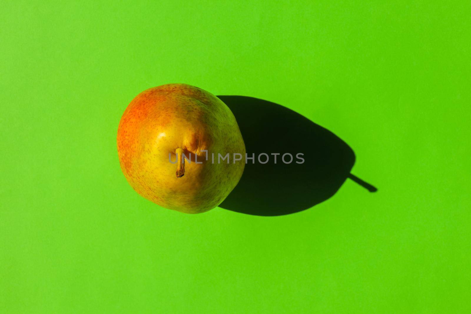 pear with a hard shadow on a plain background. the view from the top. blank for the pattern. High quality photo