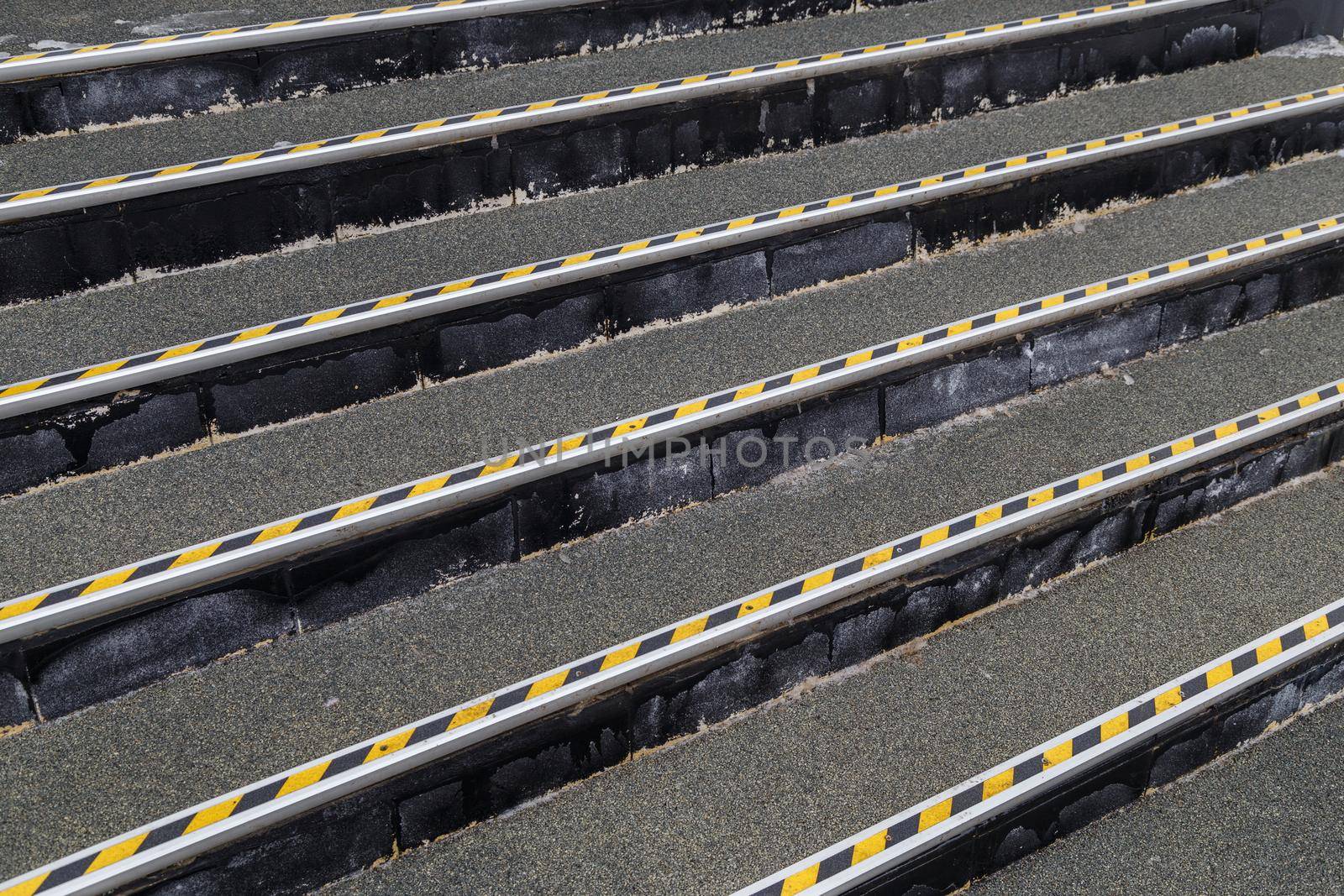 full frame background of roofing felt stairs with striped aluminium corners in diagonal perspective composition.