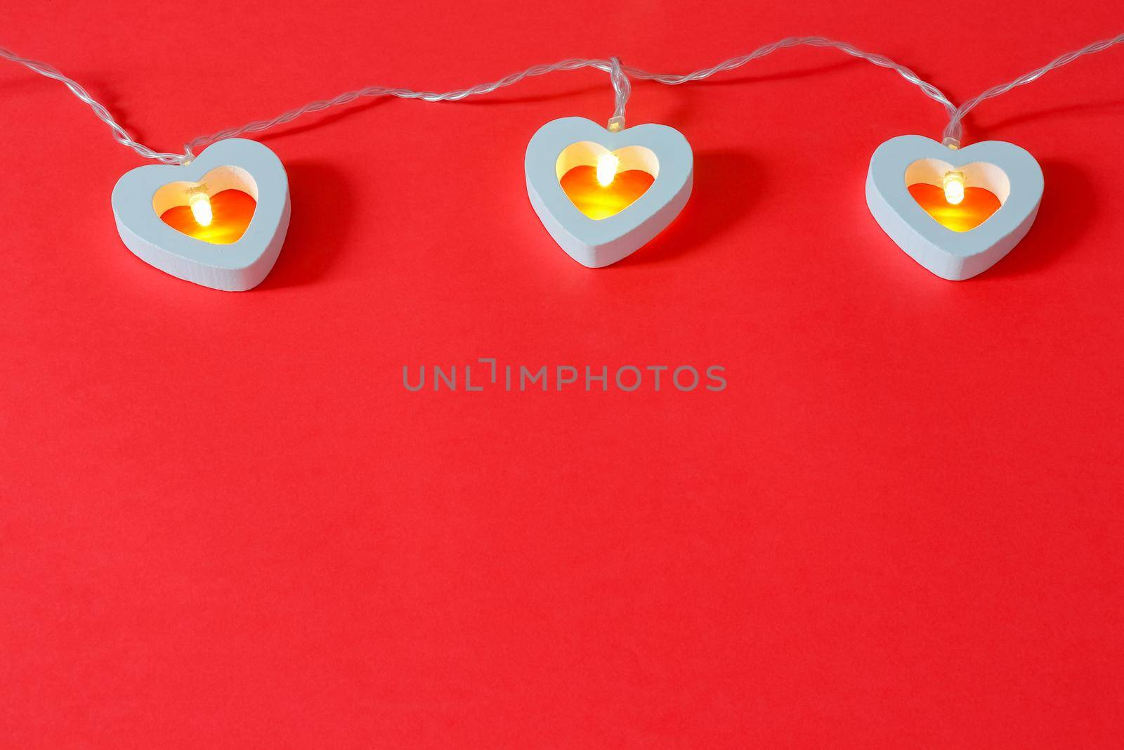 garland of hearts on a red background for Valentine's day. High quality photo