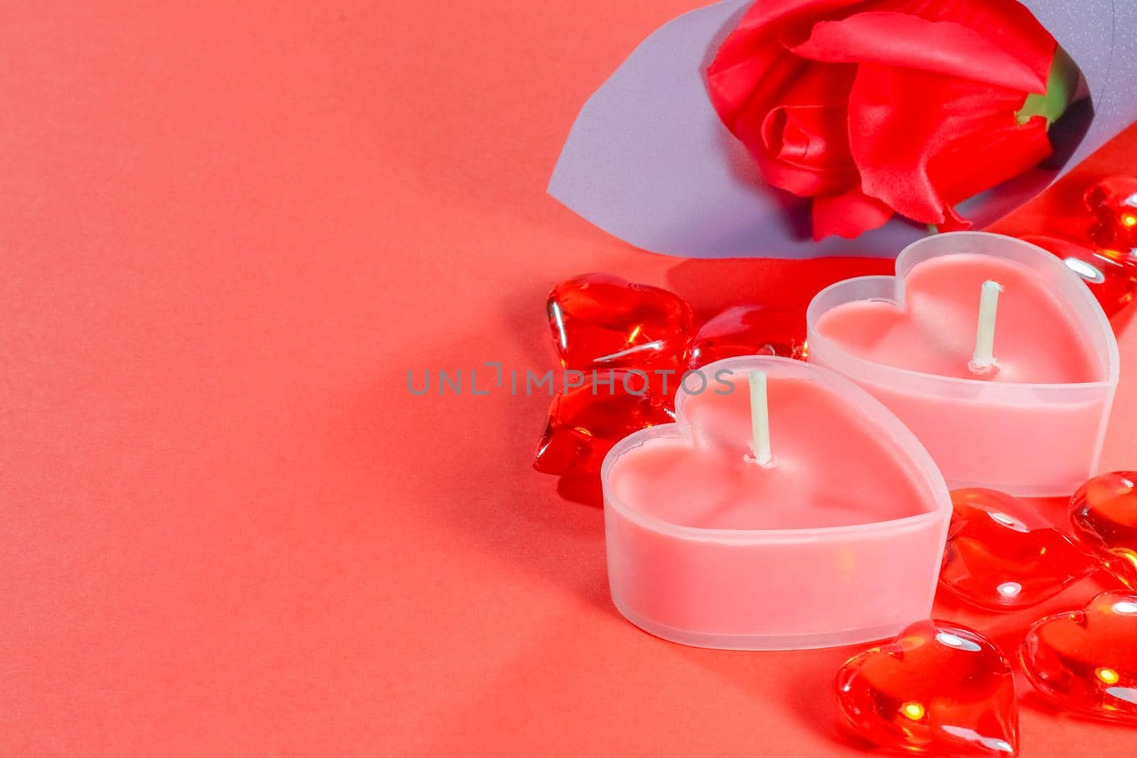 pink candles in the form of a heart on a red background for Valentine's day . High quality photo