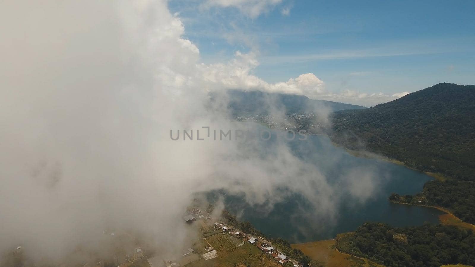 Aerial view of Lake Buyan,caldera lake at Bali. Beautiful lake with turquoise water in the mountains of the island of Bali. Landscape, lake among mountains, sky, clouds.