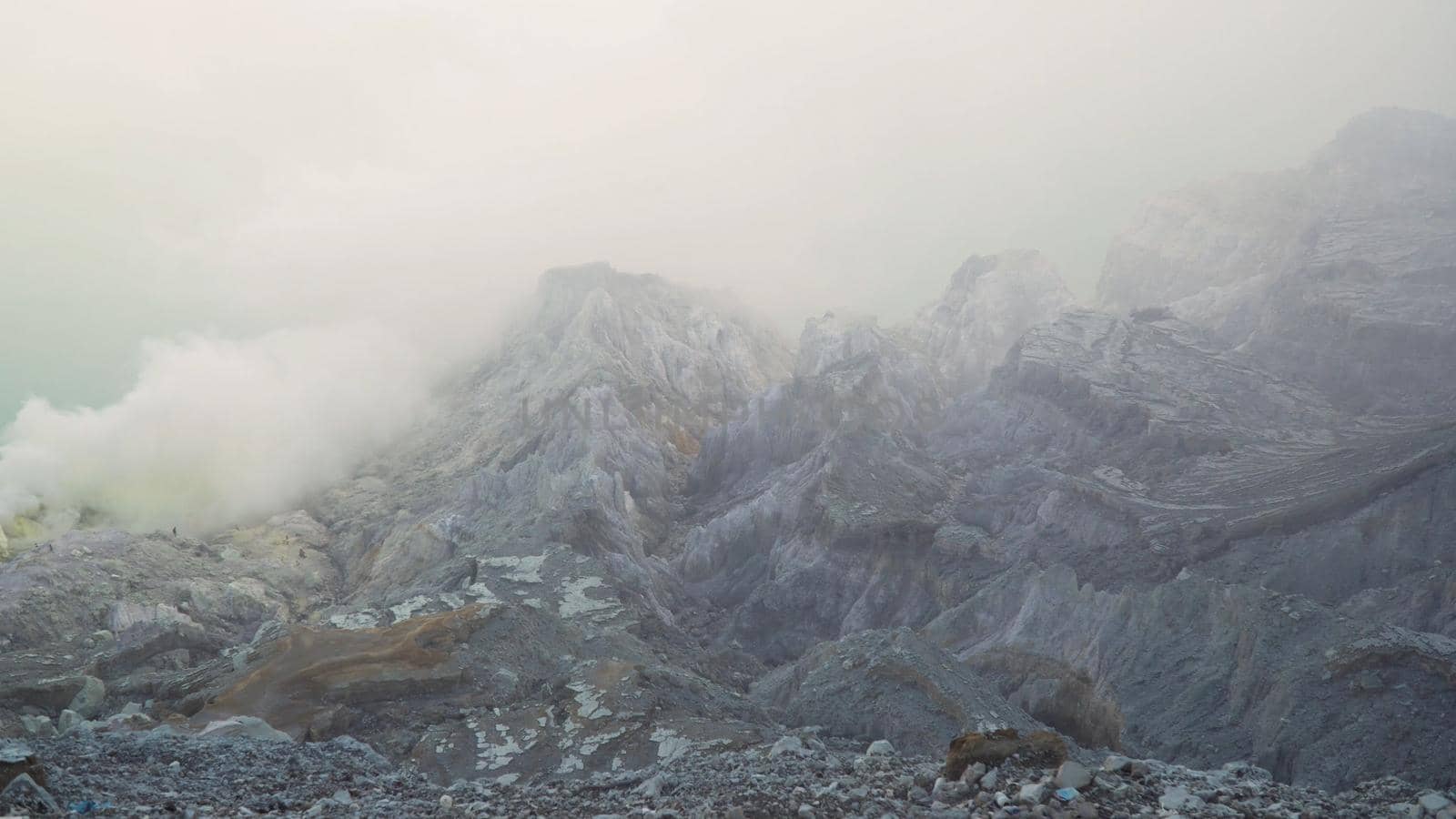 Extraction of sulfur in the crater of a volcano. Sulfur gas, smoke. Kawah Ijen, crater with acidic crater lake where sulfur is mined. Ijen volcano complex is a group of stratovolcanoes in the Banyuwangi Regency of East Java, Indonesia.