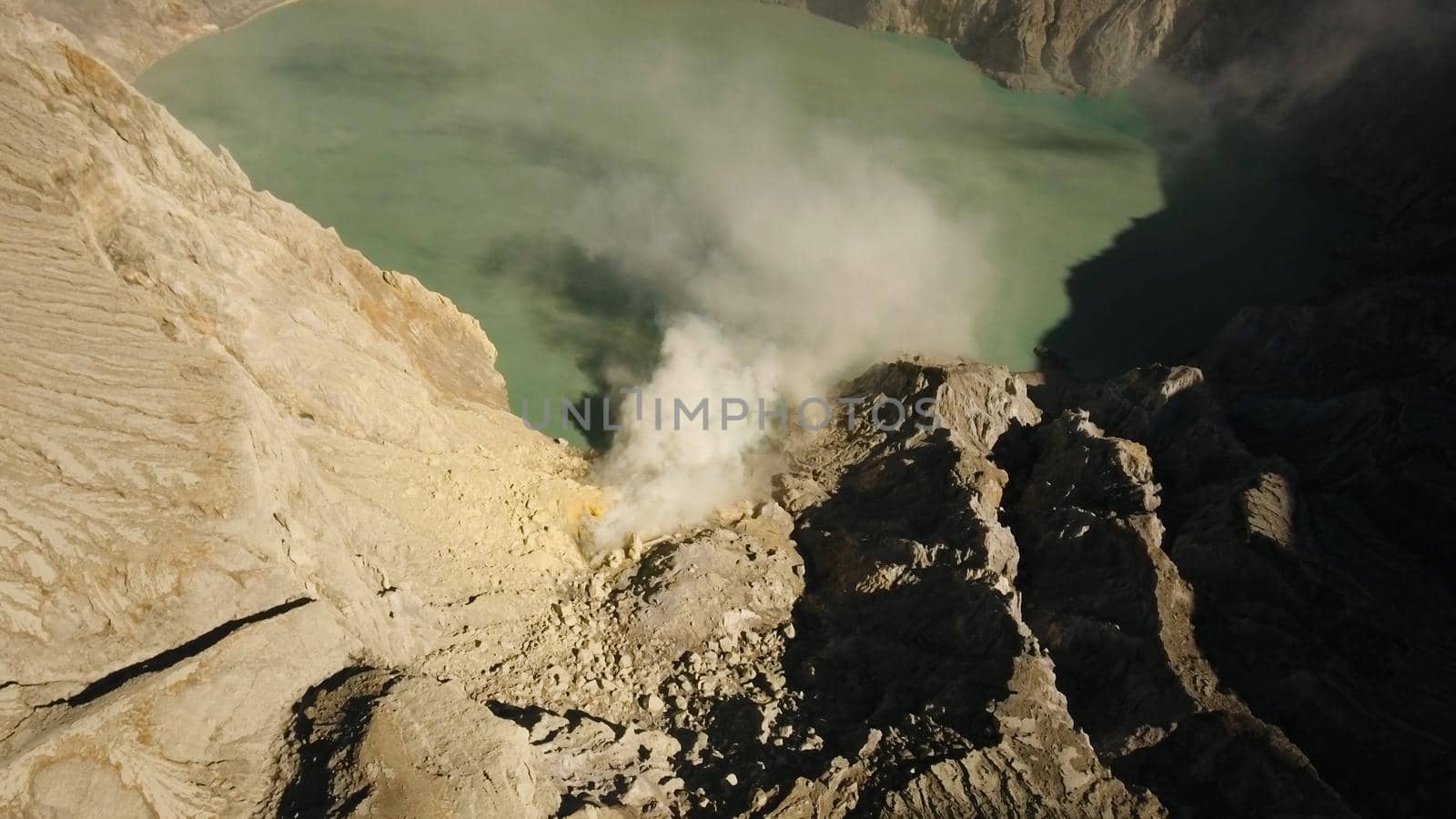 Crater with acidic crater lake, Kawah Ijen the famous tourist attraction, where sulfur is mined. Aerial view of Ijen volcano complex is a group of stratovolcanoes in the Banyuwangi Regency of East Java, Indonesia.