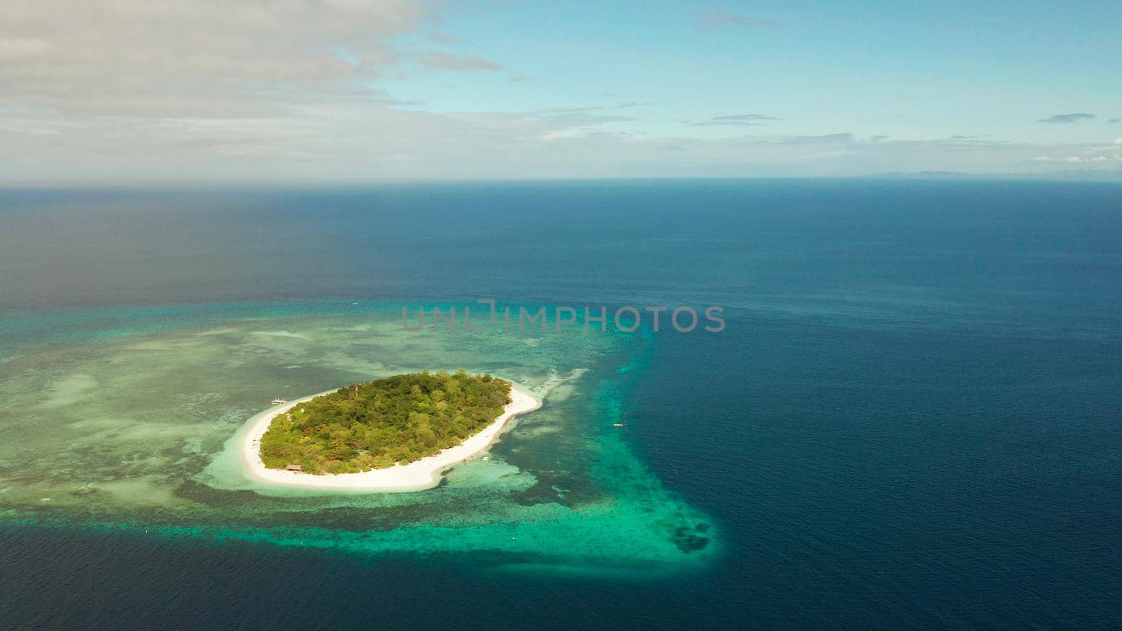 Beautiful beach on tropical island surrounded by coral reef, top view. Mantigue island. Small island with sandy beach. Summer and travel vacation concept, Camiguin, Philippines, Mindanao