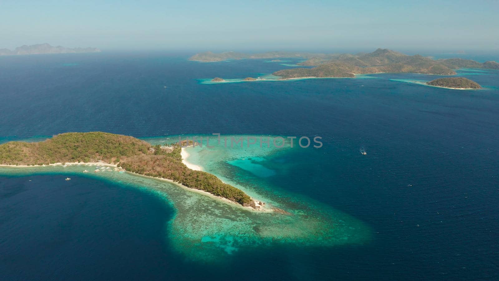 aerial view tropical islands and the blue sea. Palawan, Philippines. Islands of the Malayan archipelago with turquoise lagoons.