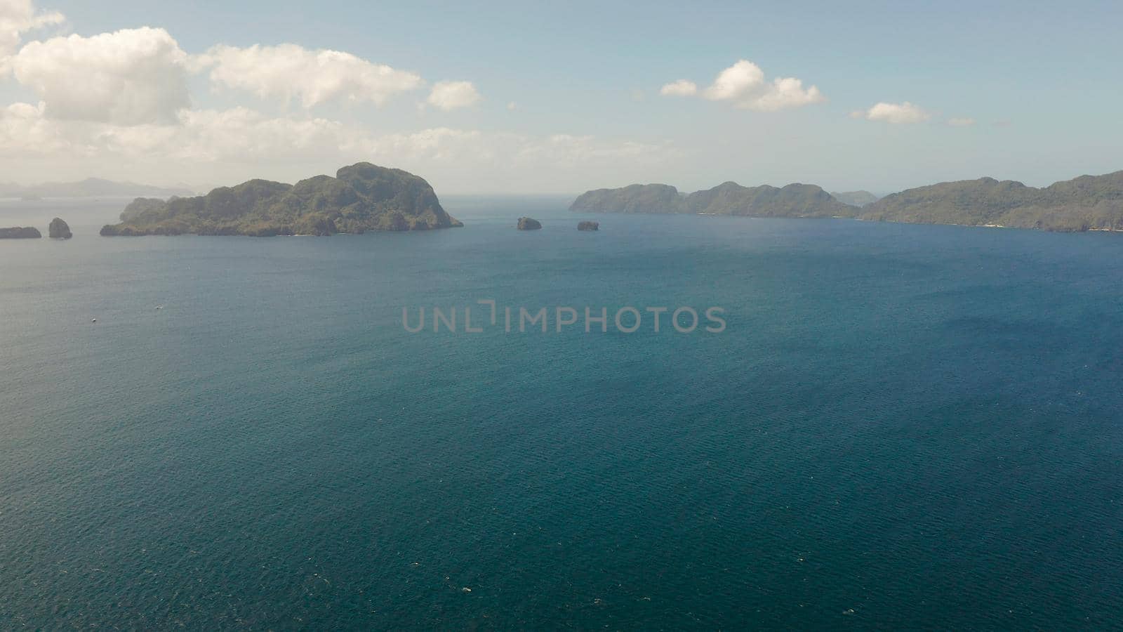 Aerial drone of Seascape with tropical rocky islands, blue water. islands and mountains covered with tropical forest. El nido, Philippines, Palawan