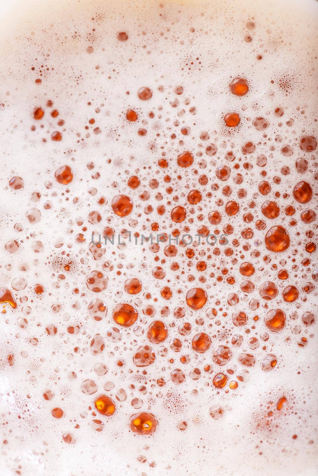 Light Beer with Bubbles and Foam Background. Beer Bubbles Texture Close Up.