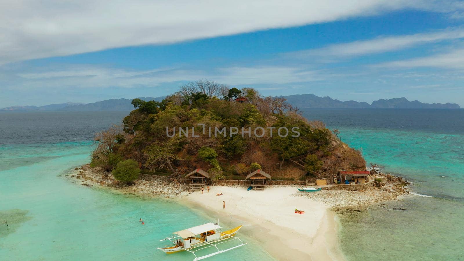 aerial seascape tropical island and sand beach, turquoise water and coral reef. malacory island, Philippines, Palawan. tourist boats on coast tropical island.
