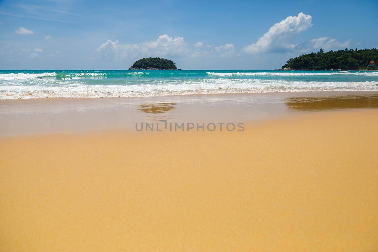 Beautiful sea Sunny landscape on the beach. Light waves of blue color spread all over the beach smoothly smoothing the Golden sand.