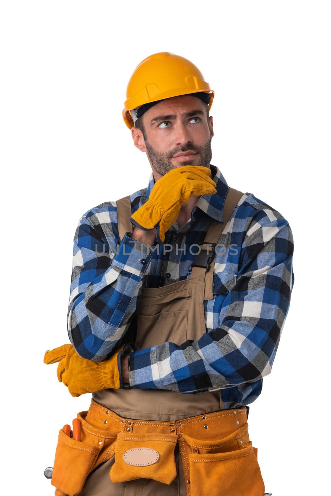 Portrait of contractor worker in coveralls and hardhat holding chin isolated on white background