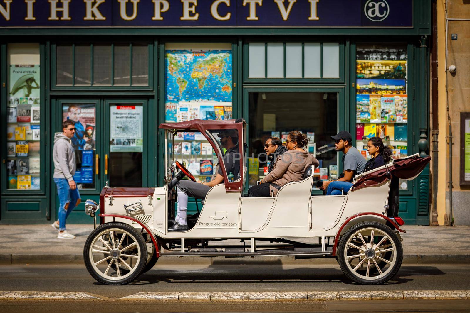 Czech Republic 14 april 2018 Vintage cars for tourist excursions. Beige convertible car on the road with tourists.