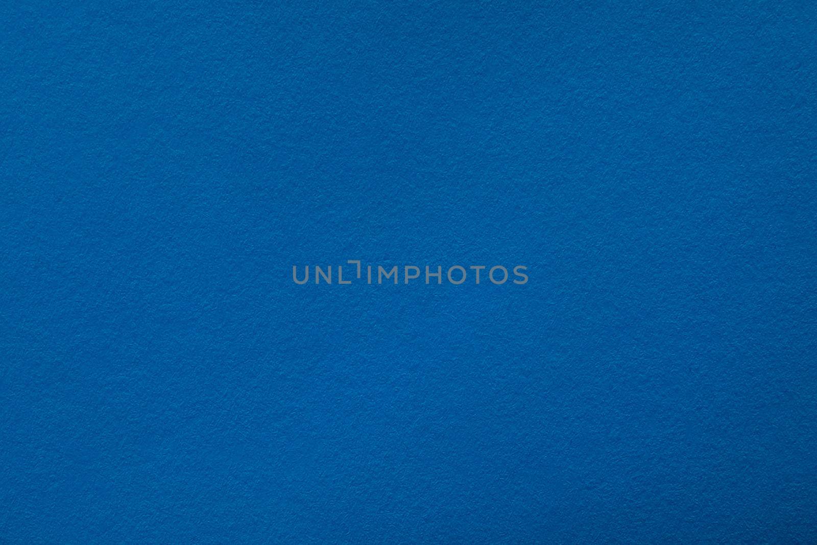 Blue background with paper texture, horizontal, blank space.