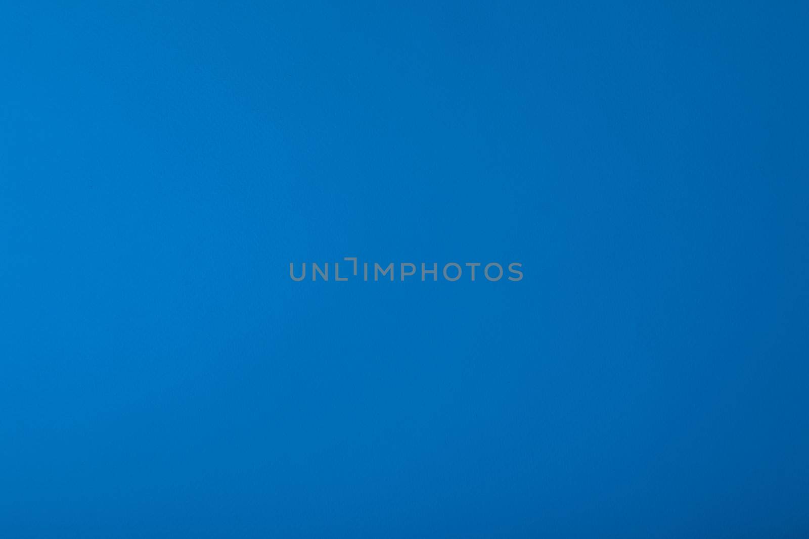 Blue background with paper texture, horizontal, blank space.