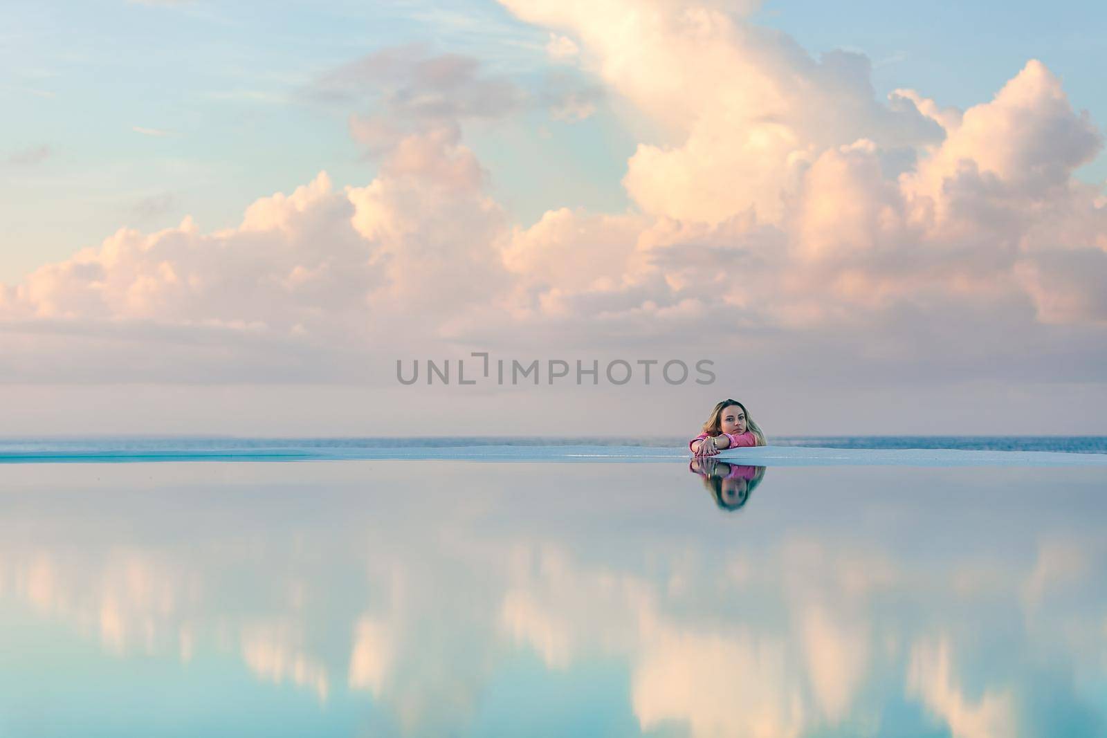 Young girl at dawn by the sea pool, calm and relaxed by Yurich32