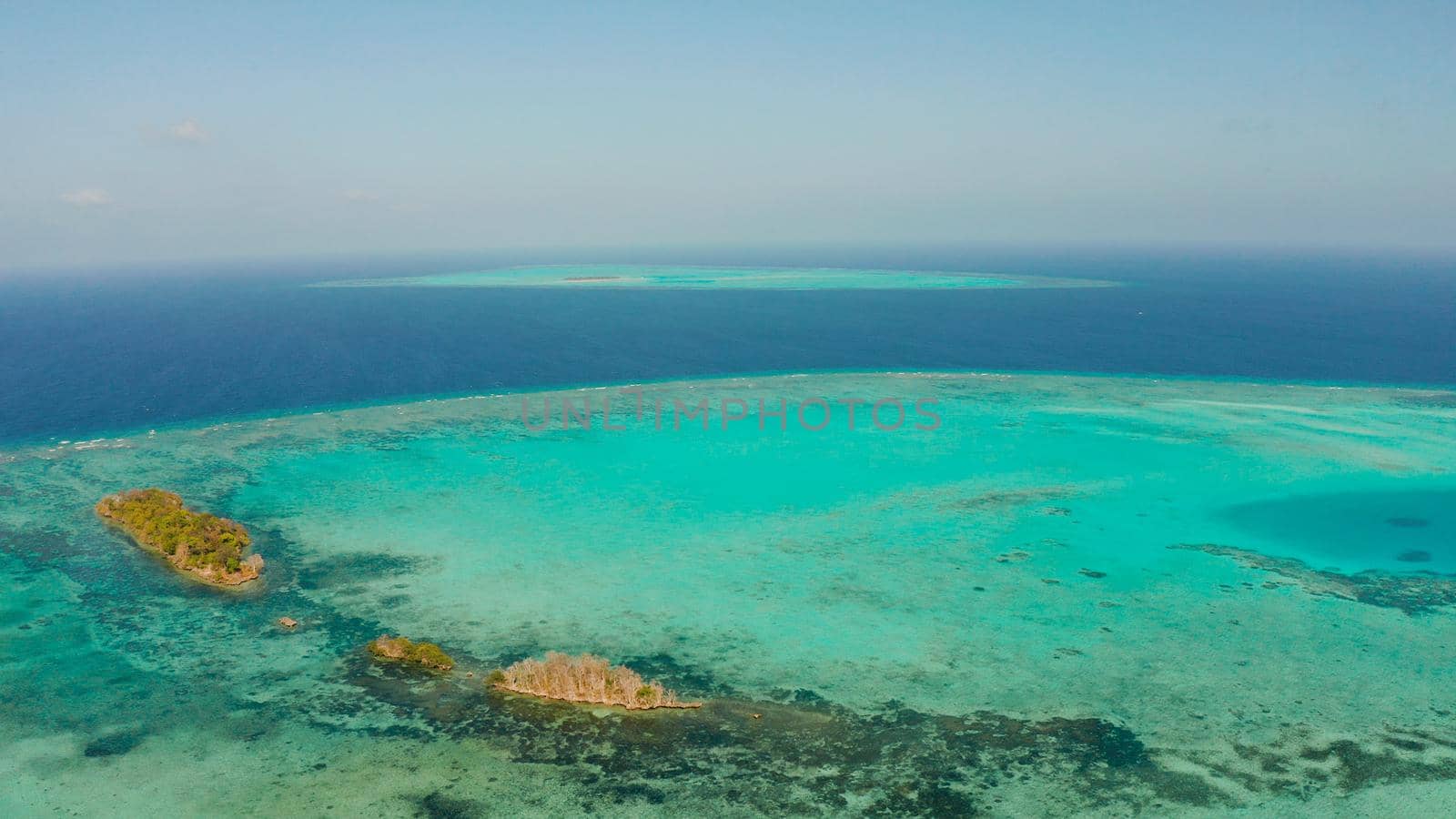 Tropical islands surrounded by an atoll and a coral reef view from above. Balabac, Philippines. Summer and travel vacation concept