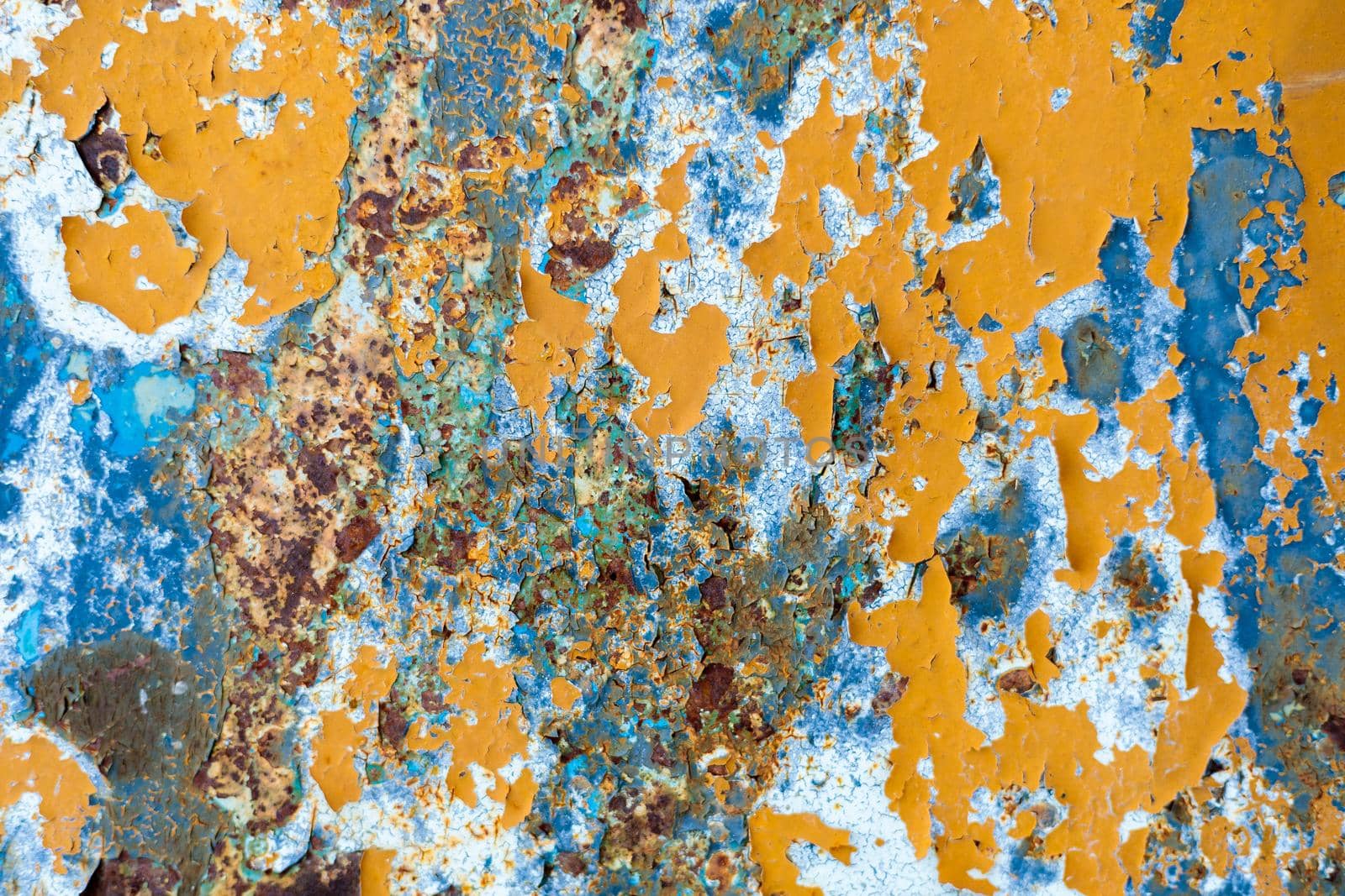 Rust, steel, background. Peeling off old paint Blue yellow white