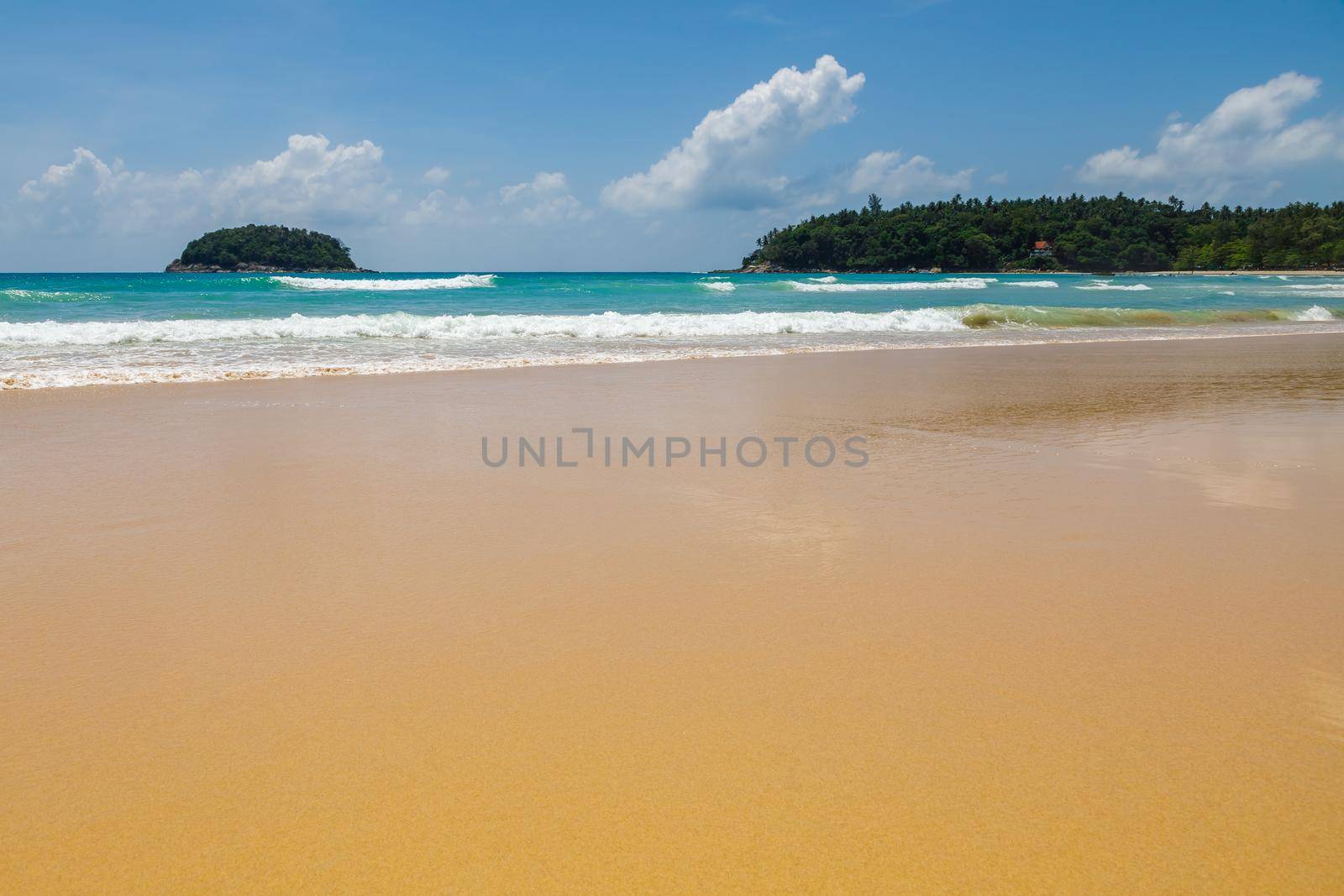 Beautiful sea Sunny landscape on the beach. Light waves of blue color spread all over the beach smoothly smoothing the Golden sand.