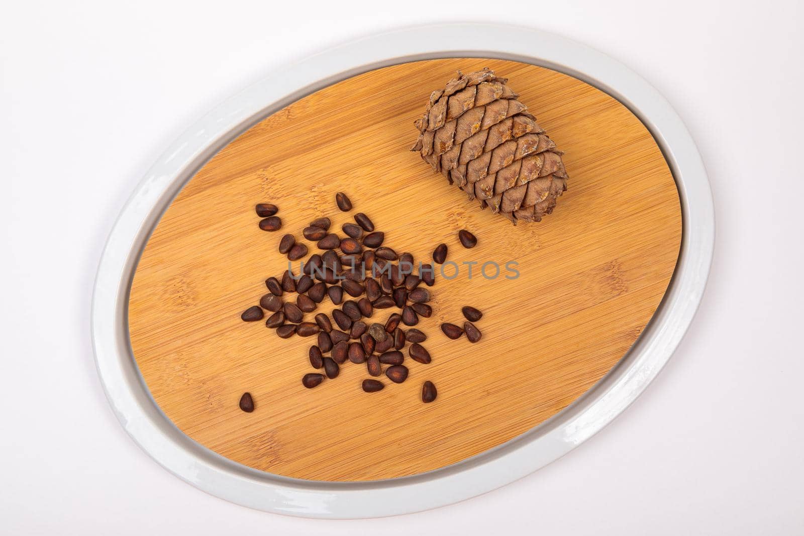 The fruit of Siberian cones - pine nuts on a kitchen cutting board, is a delicious, nutritious and healthy product.