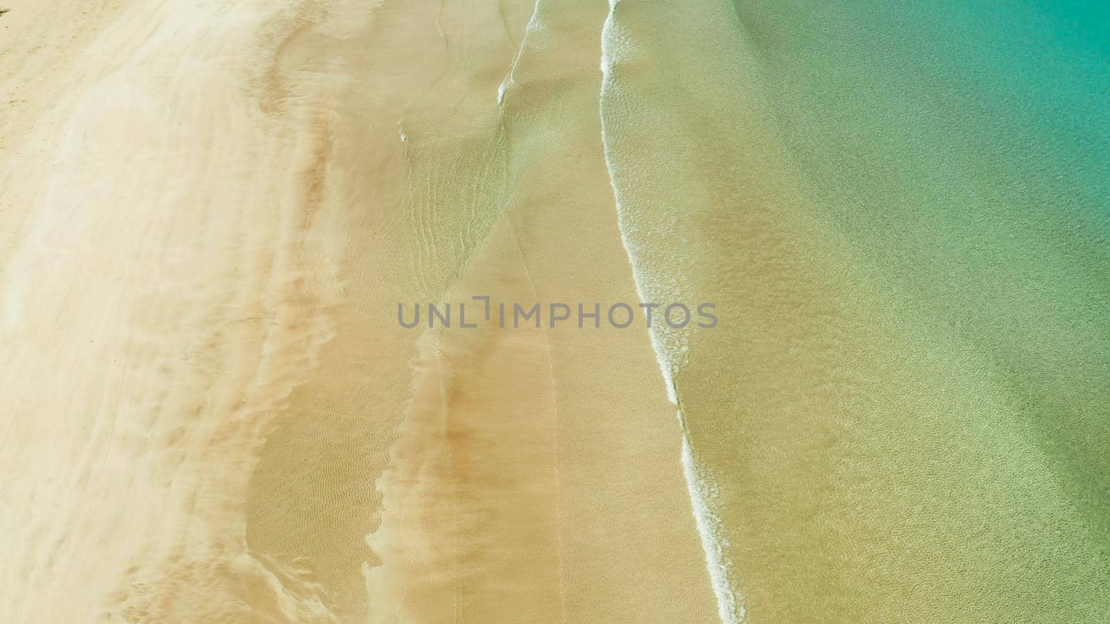 aerial view Tropical sandy beach and sea with clear water,space for text. Ocean with waves and yellow beach. Summer and travel vacation concept