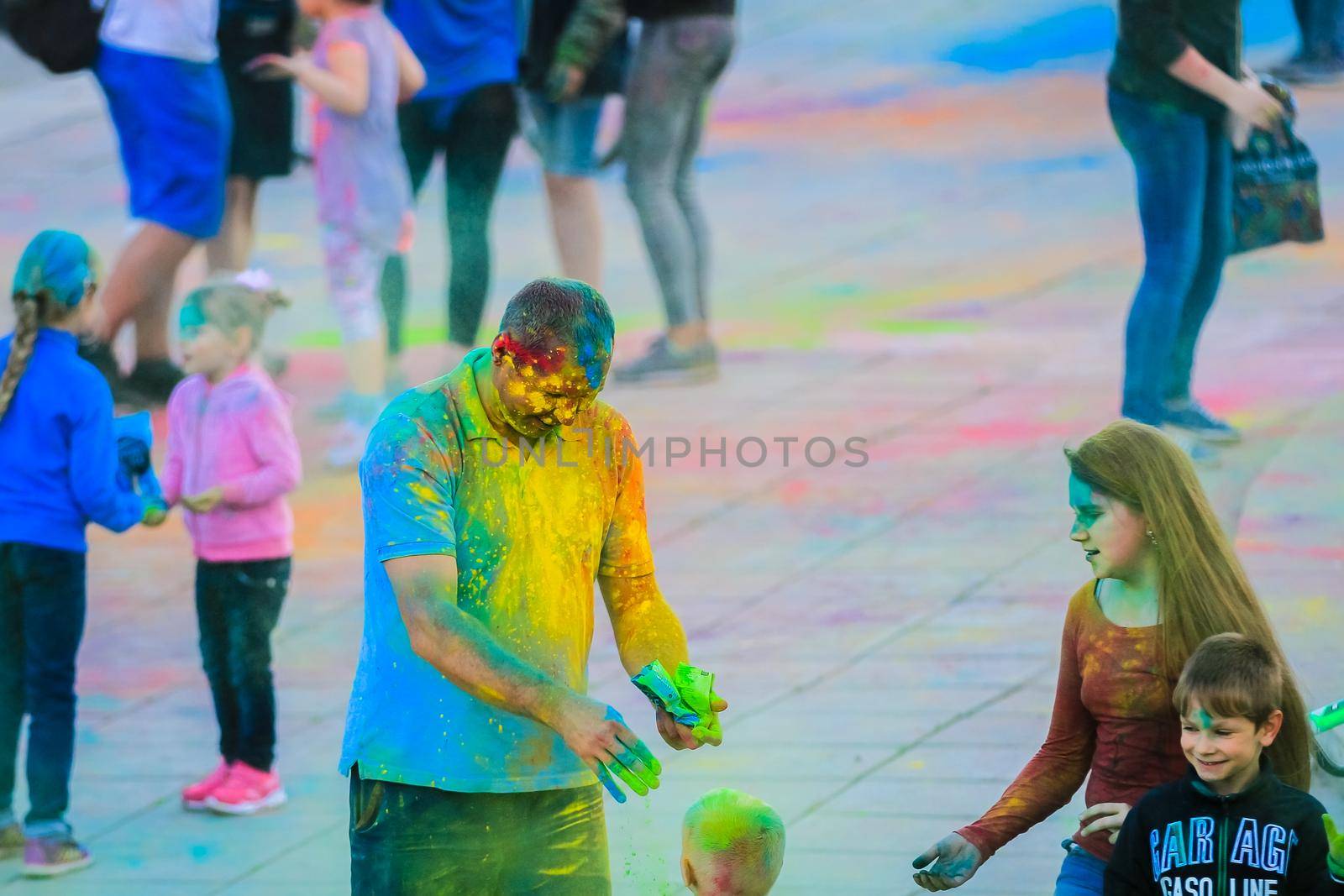 Russia, Moscow - June 25, 2017. A grown man with bright colors on his face. Laughs with happiness. Holi is a traditional holiday in India