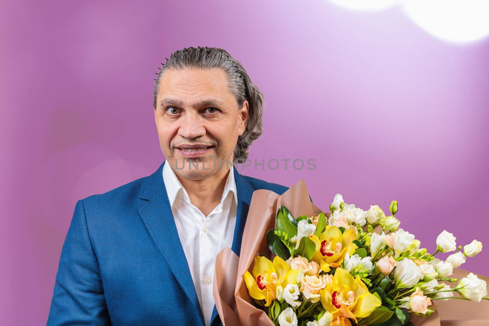 Smiling 50 year old man in suit with bouquet of flowers by Yurich32