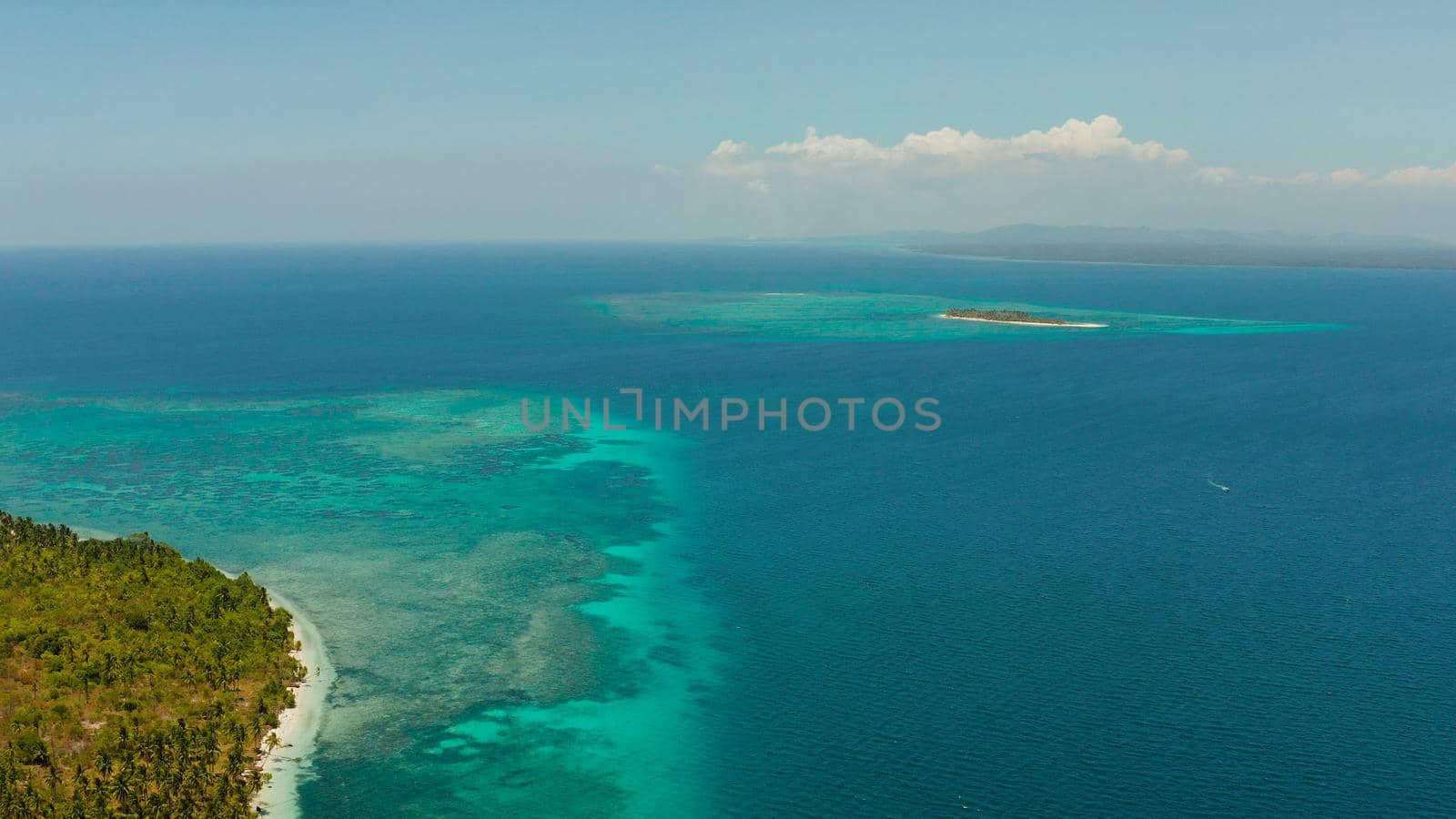 Sandy beach and tropical islands by atoll with coral reef, top view. Patongong Island with sandy beach. Summer and travel vacation concept.