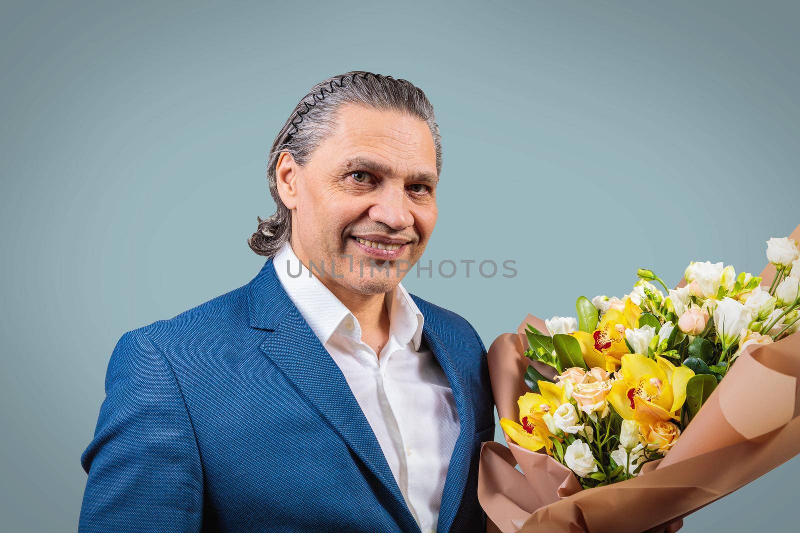 Smiling 50 year old man in suit with bouquet of flowers by Yurich32