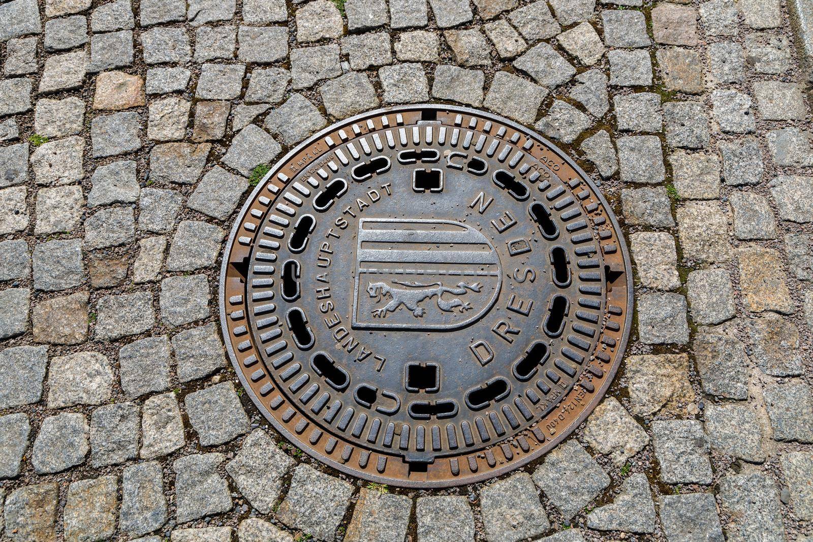 Dresden, Germany, April 18, 2018: Manhole cover made of cast iron of the city sewer system of Dresden.