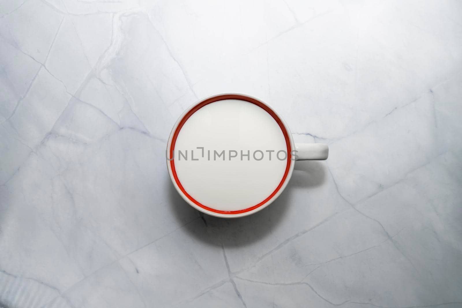 a mug of milk on the marble table. the view from the top. High quality photo