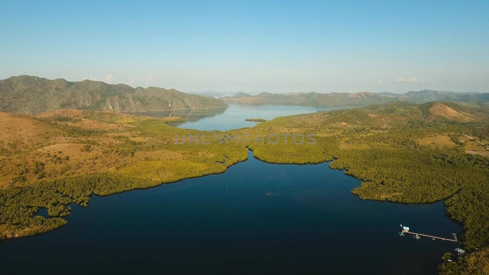 Tropical landscape, at sunrise time with mountains, tropical forest, bay, mangrove forest. Aerial view Seashore with jungle. Coron, Philippines,Palawan, Busuanga. Travel concept