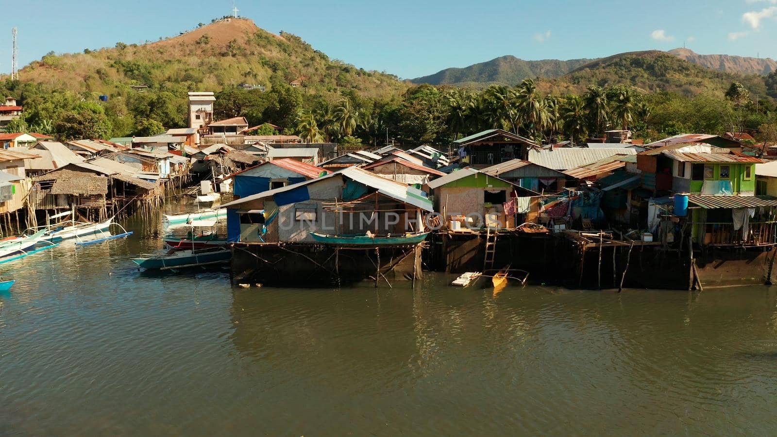 Old wooden house standing on the sea in the fishing village. Busuanga, Coron, Philippines. houses community standing in water in fishing village. Coron city with slums and poor district.