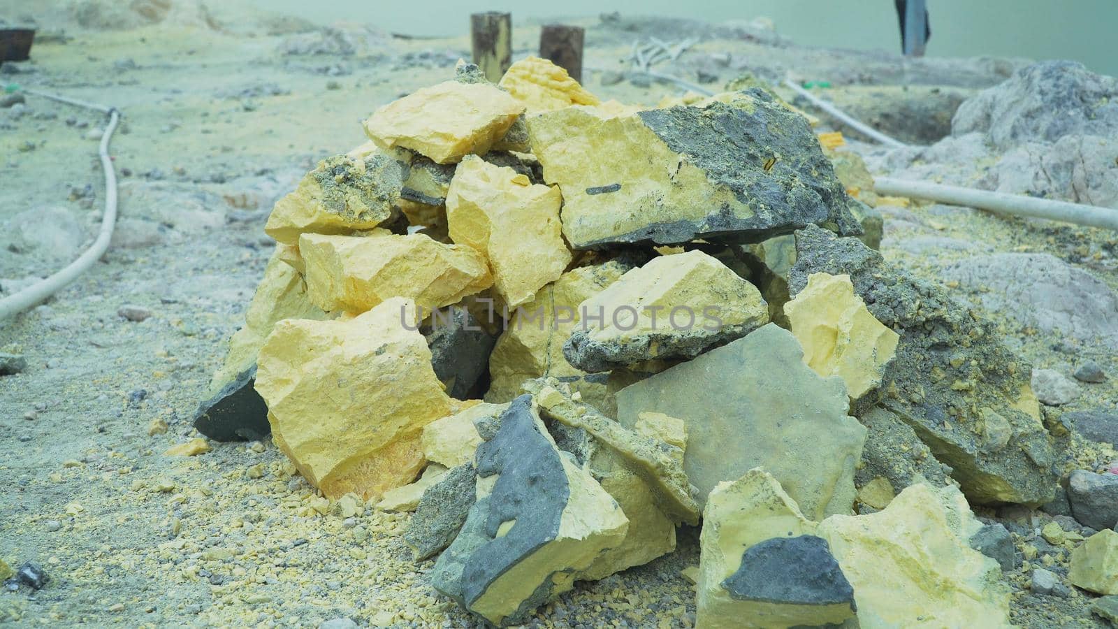 Extraction of sulfur in the crater of a volcano. Sulfur gas, smoke. Kawah Ijen, crater with acidic crater lake where sulfur is mined. Ijen volcano complex is a group of stratovolcanoes in the Banyuwangi Regency of East Java, Indonesia.