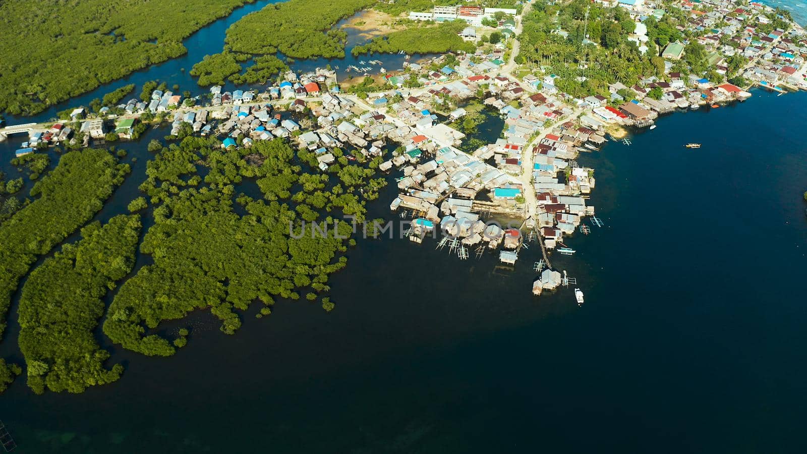 Village near mangroves in the bay of the ocean, top view. Siargao island, Philippines.