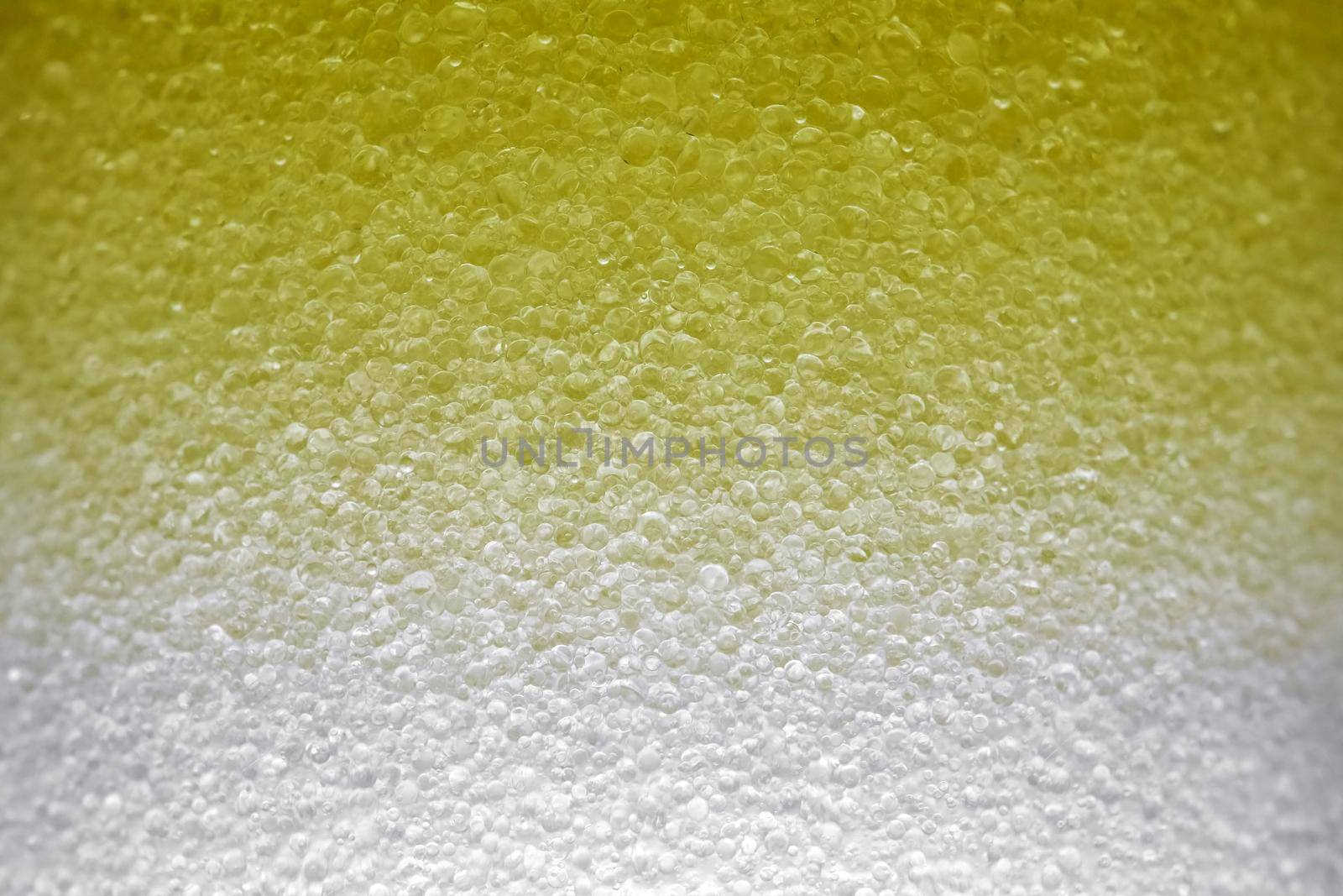 yellow bubbles of micellar water macro as background. high-quality photos