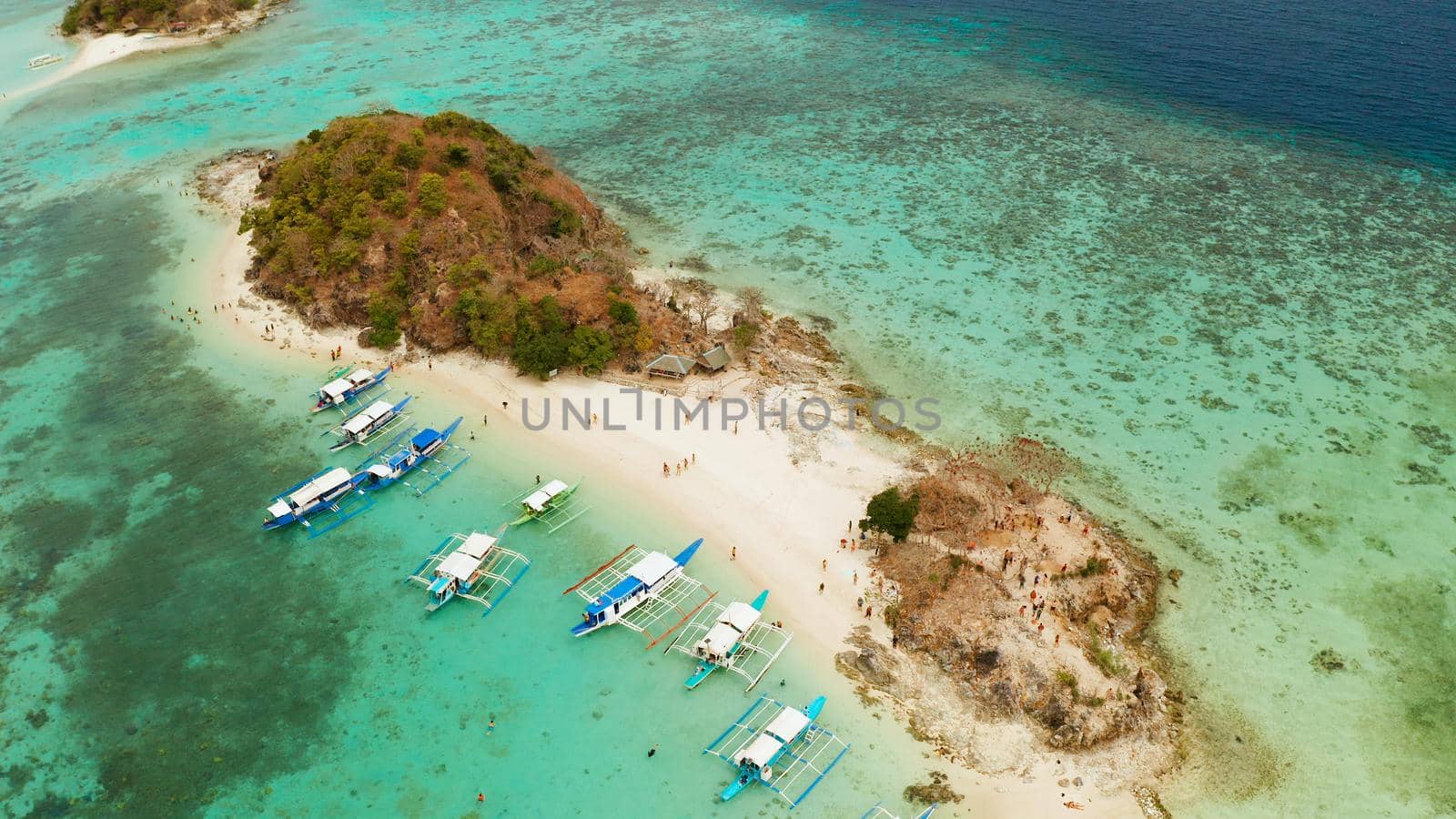 aerial view tropical island with sand white beach. Bulog Dos, Philippines, Palawan. Seascape bay with turquoise water and coral reef.