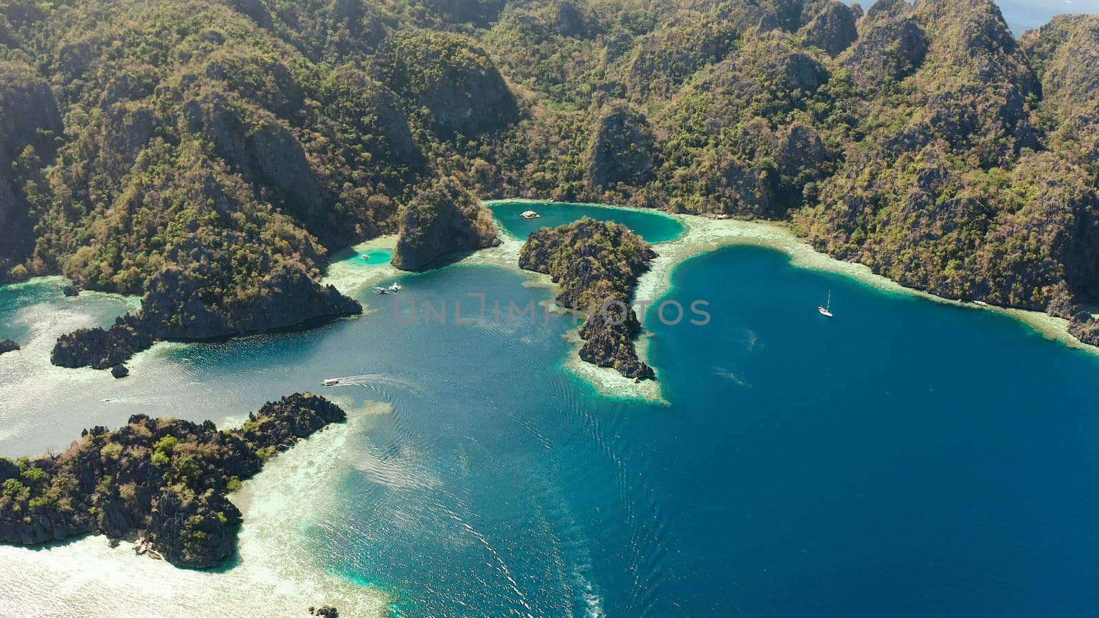 Aerial drone lagoons and coves with blue water among the rocks. lagoon, mountains covered with forests. Seascape, tropical landscape. Palawan, Philippines, Busuanga