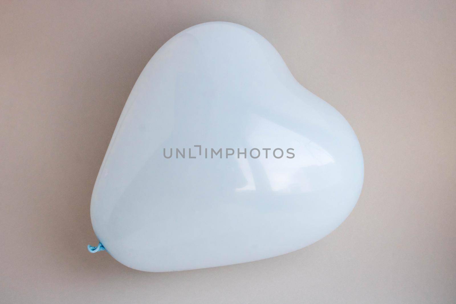 Blue balloon in the shape of a heart on a gray background. Wedding concept, Valentine's Day, photo zone, lovers. Banner. top view. Space for your text.