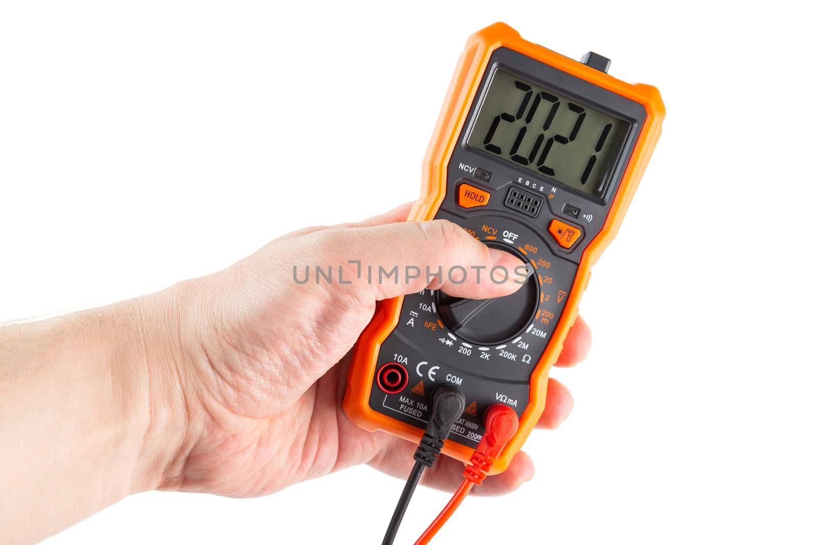digit 2021 on lcd screen of digital electrical multimeter in left caucasian hand, isolated on white background
