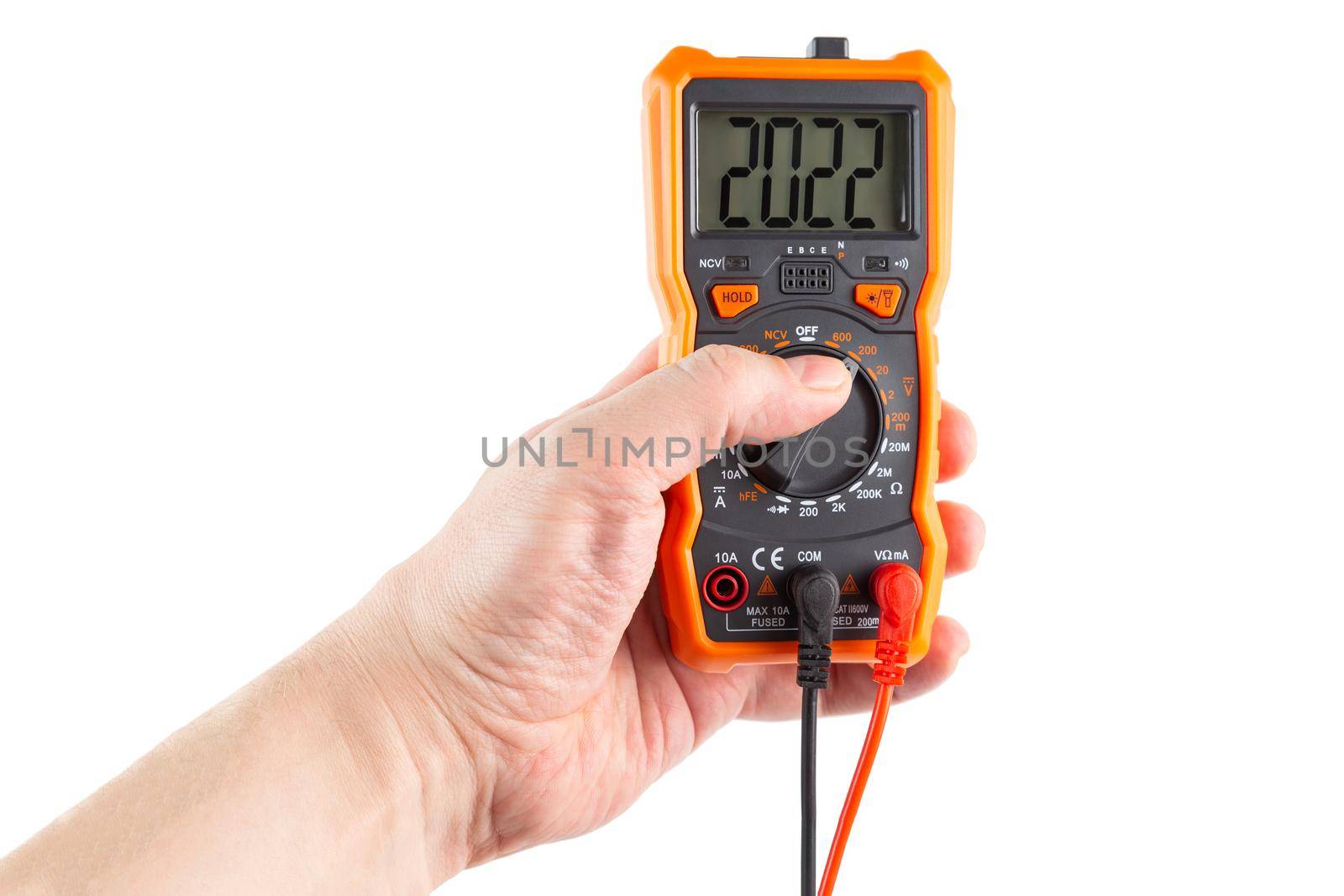 digit 2022 on lcd screen of digital electrical multimeter in left caucasian hand, isolated on white background