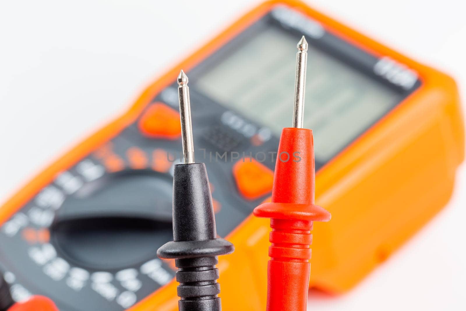 close-up view of digital electrical multimeter probe tips with selective focus and natural background blur