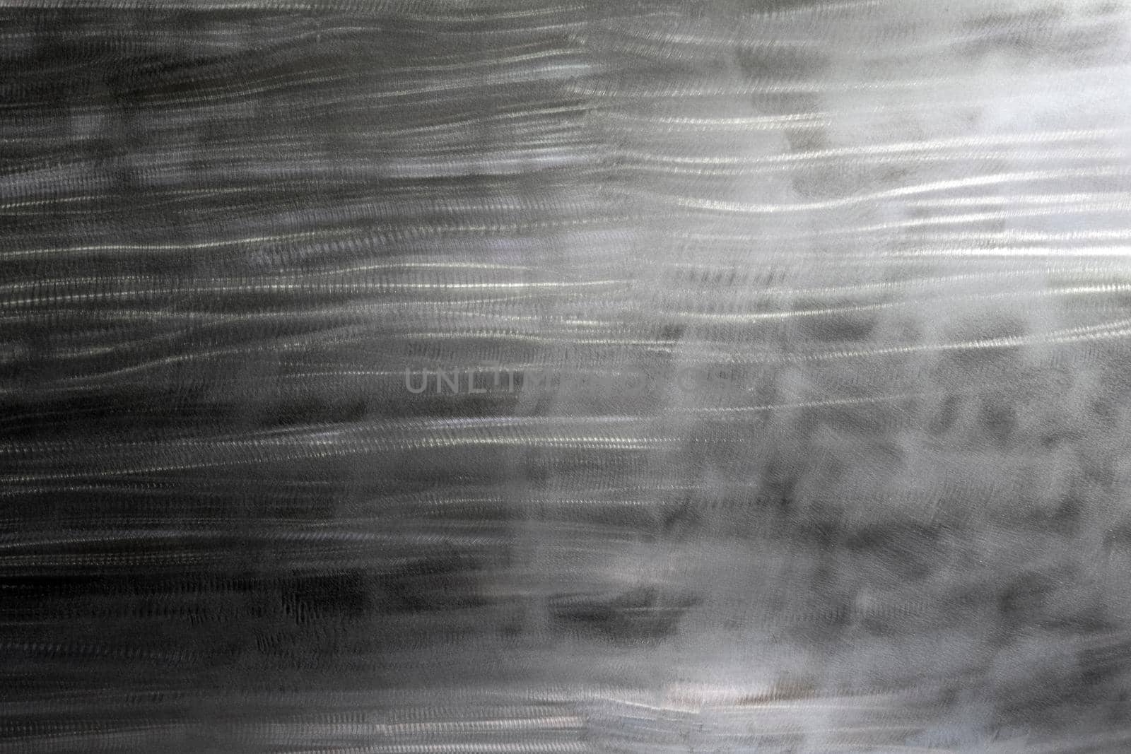 Close-up texture of flat steel surface manually cleaned with a flap wheel angle grinder. Surface prepaired before painting as part of the repair work.