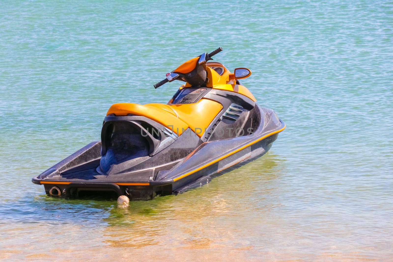 a jet ski stands on the water without people. High quality photo